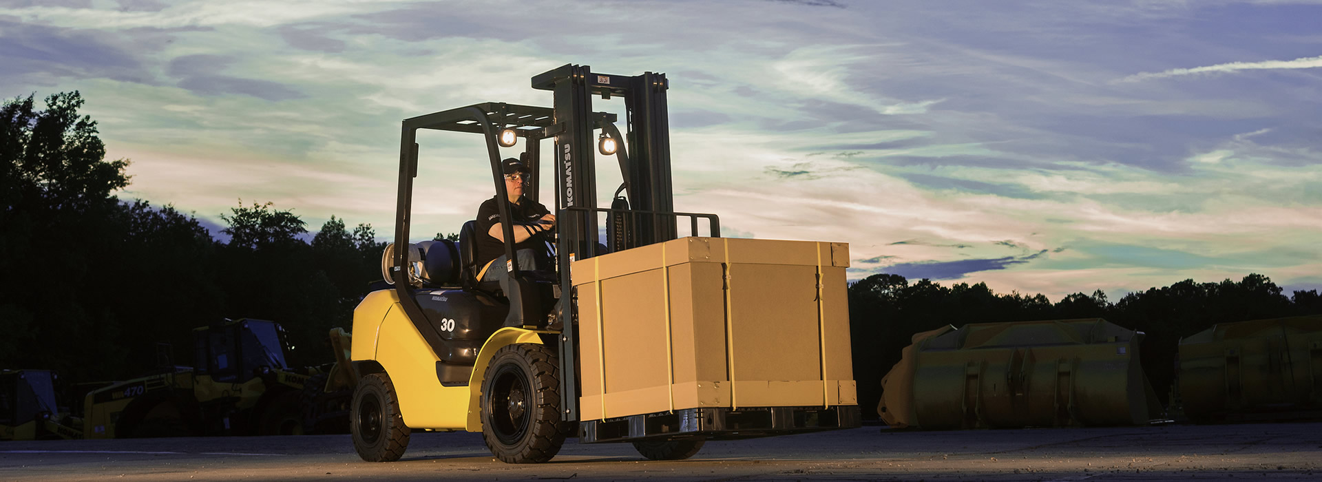 forklift carrying a large box